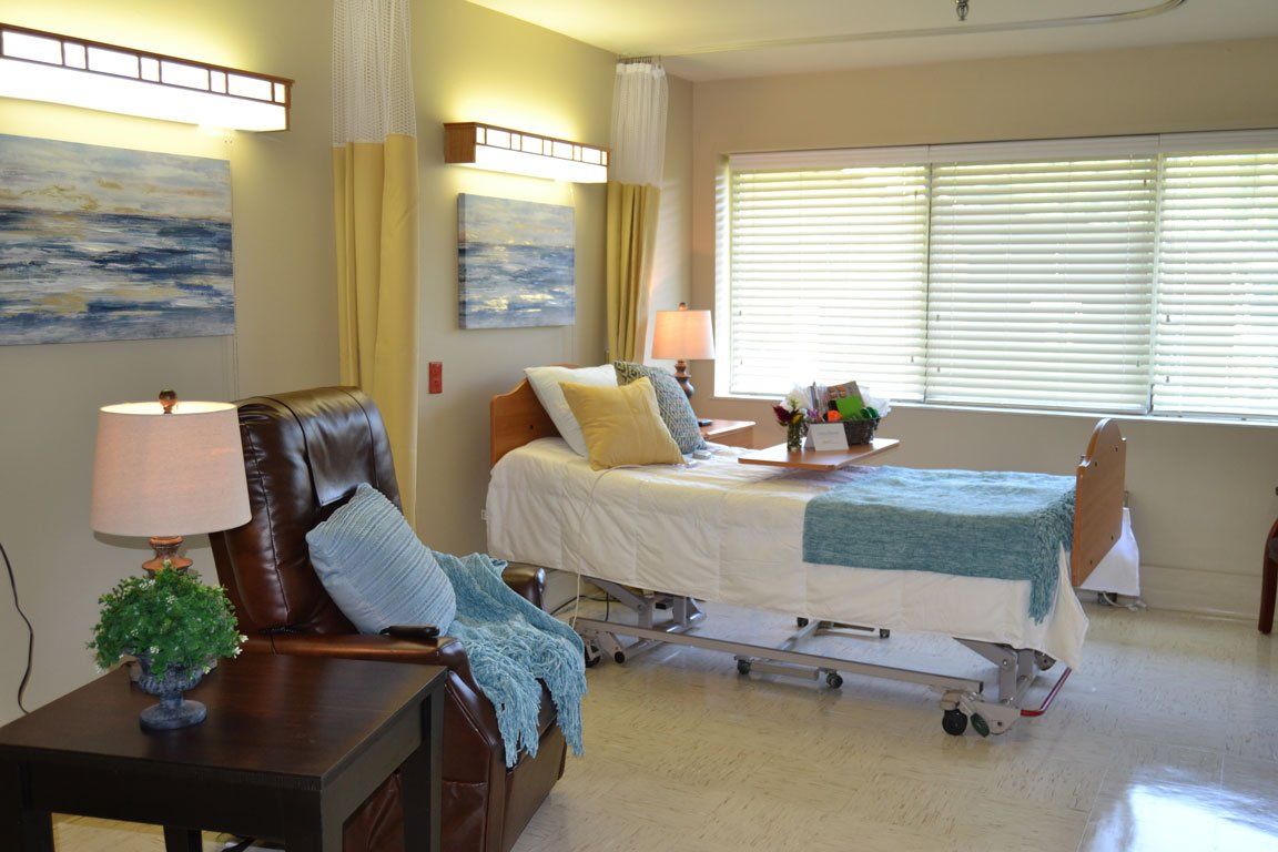 A hospital room with a bed and a chair