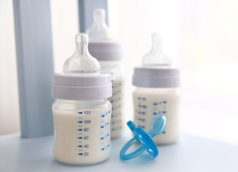 Three baby bottles and a pacifier