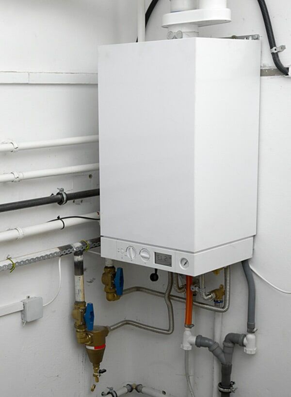 Hot Water System Attached On A Wall — Electrician in Newtown, QLD Hot Water System Attached On A Wall — Electrician in Newtown, QLD
