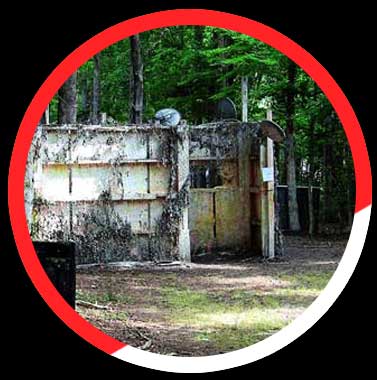 Click here to see more details. An old building in the middle of a forest with a red circle around it.