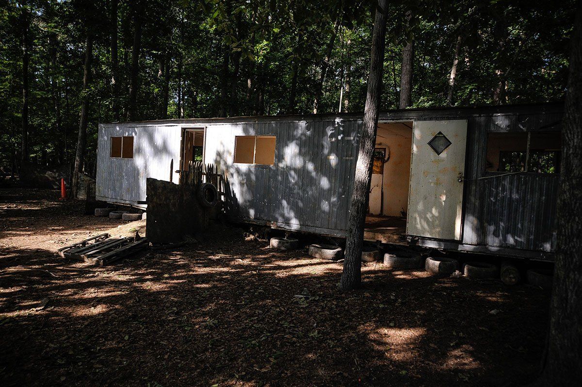 A trailer is parked in the middle of a forest.