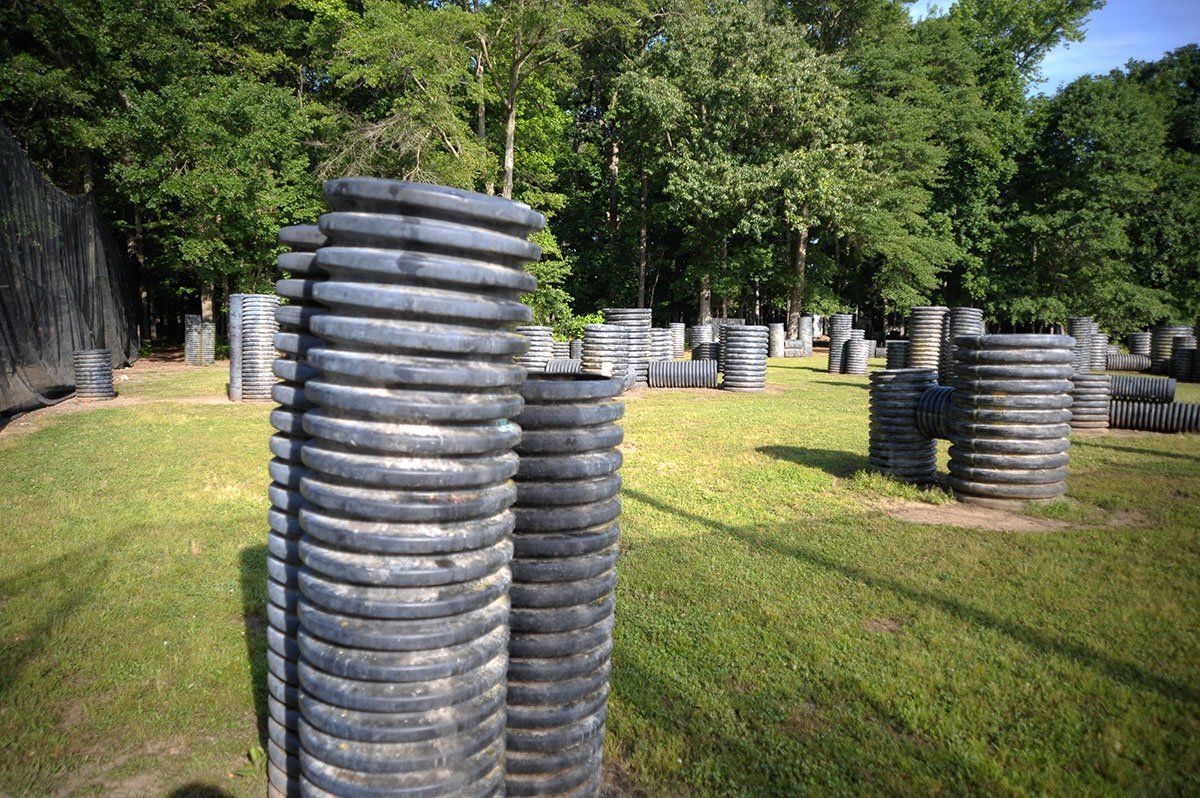 A paintball field with a lot of tires stacked on top of each other.