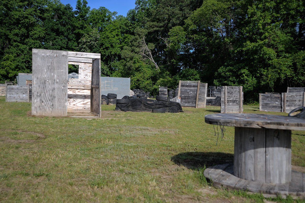 A paintball field with a wooden table in the middle of it.
