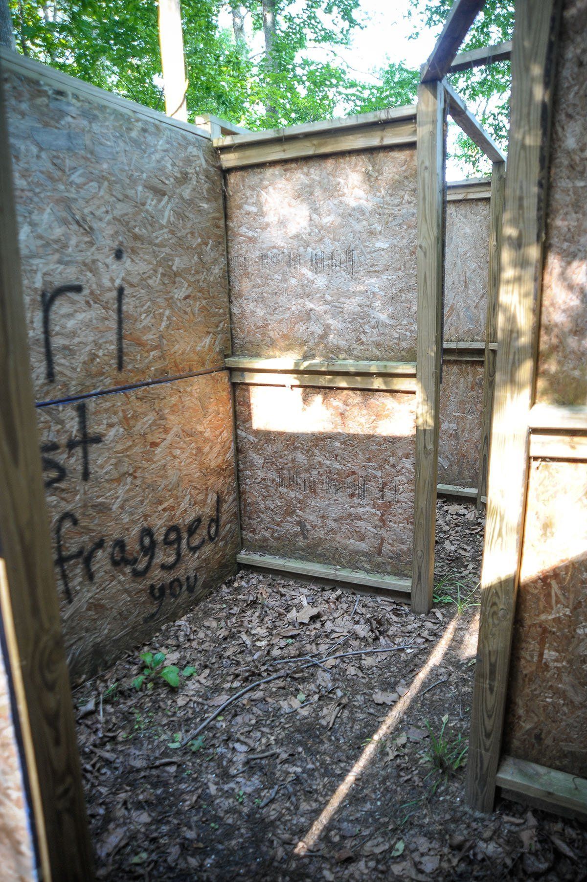 A wooden fence with the words fragged written on it.