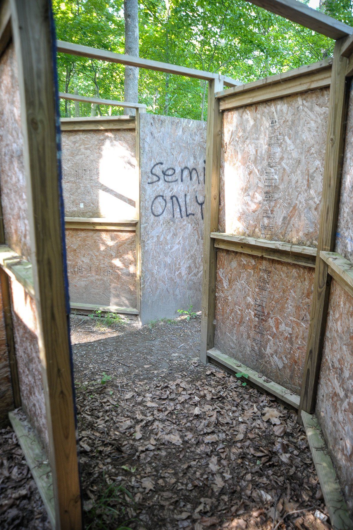 A wooden fence with a sign that says semi only on it.