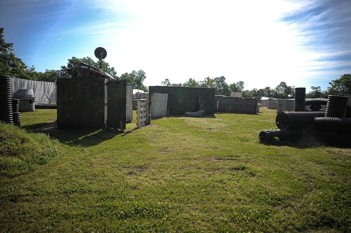 A field of grass with a lot of buildings in the background