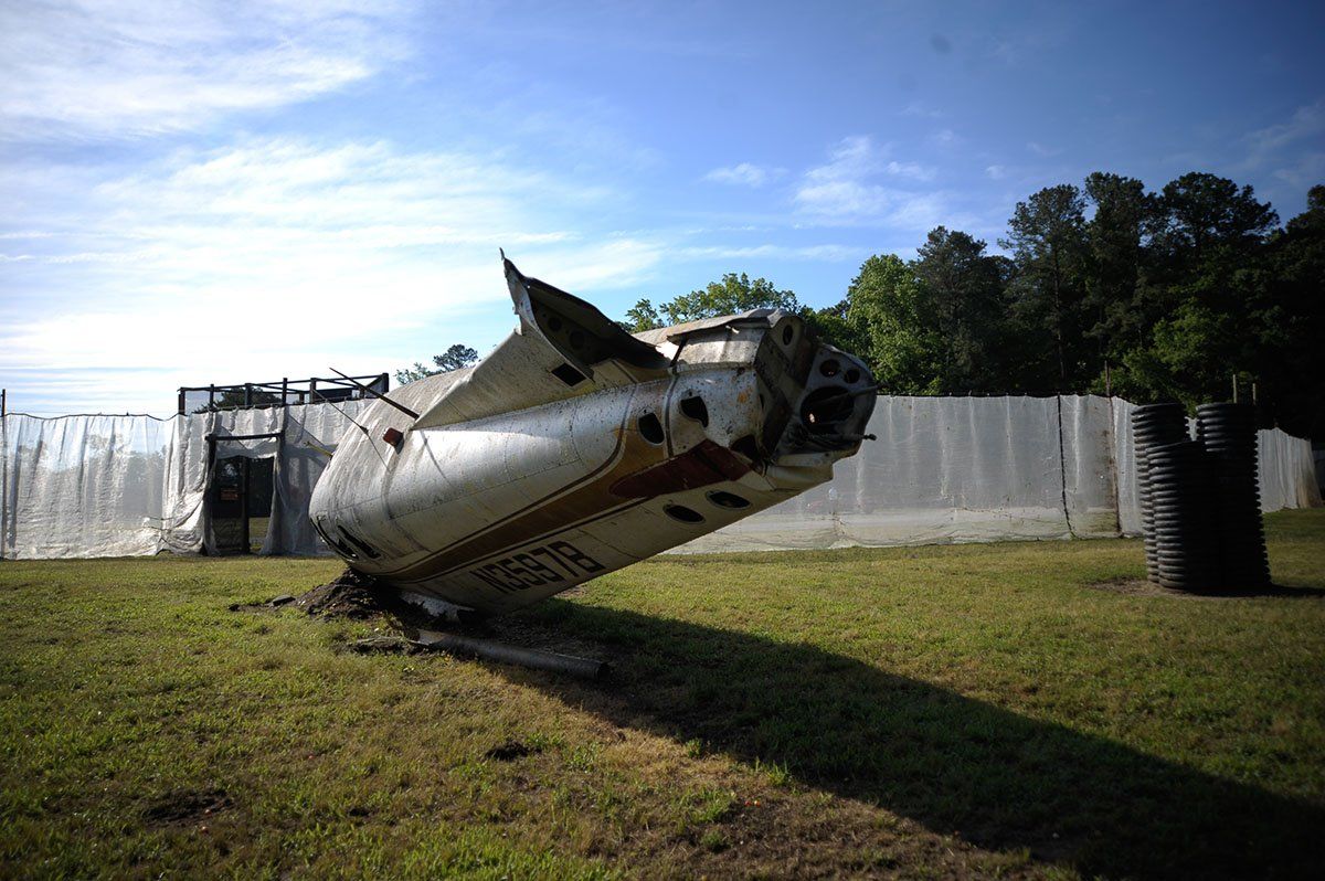 Mout Site Field - Downed Airplane A plane is laying on its side in a grassy field.