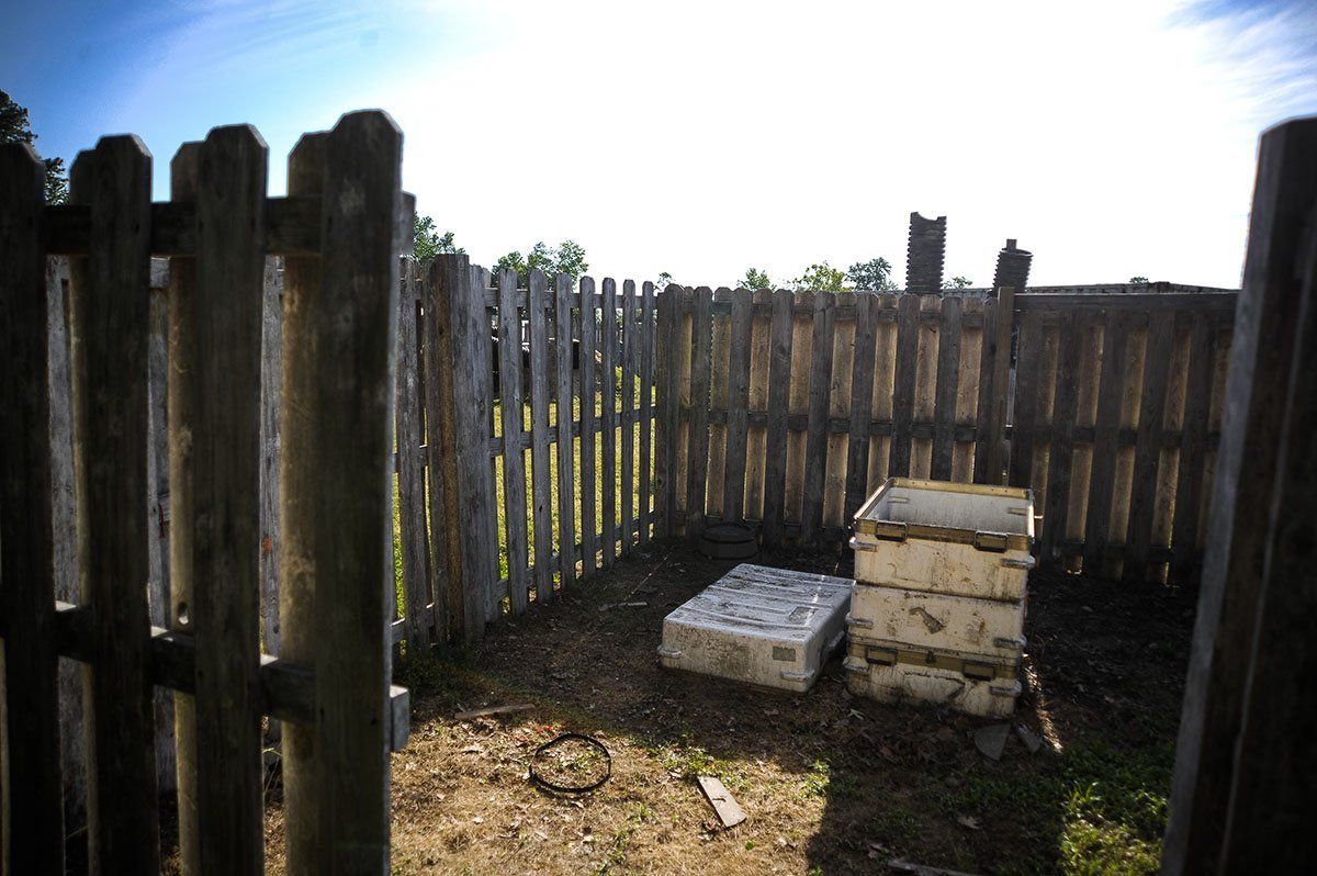 A wooden fence with a box in the middle of it