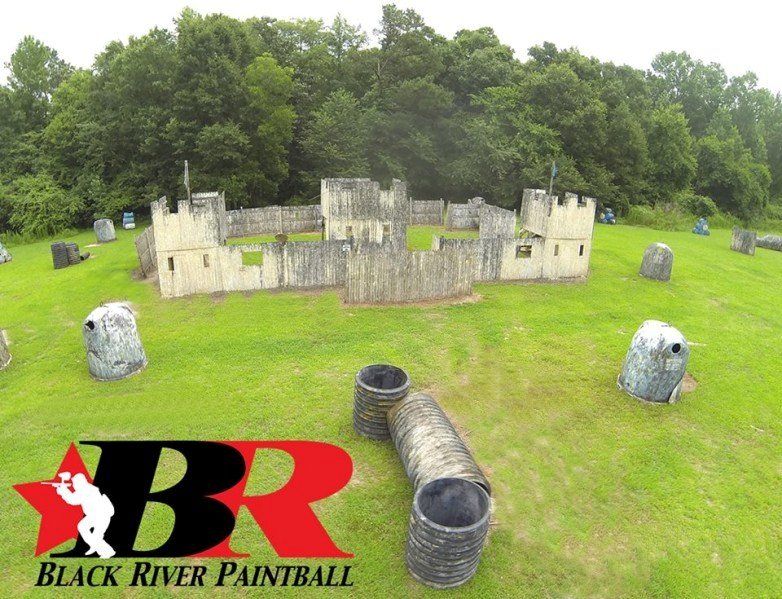 An aerial view of a black river paintball field