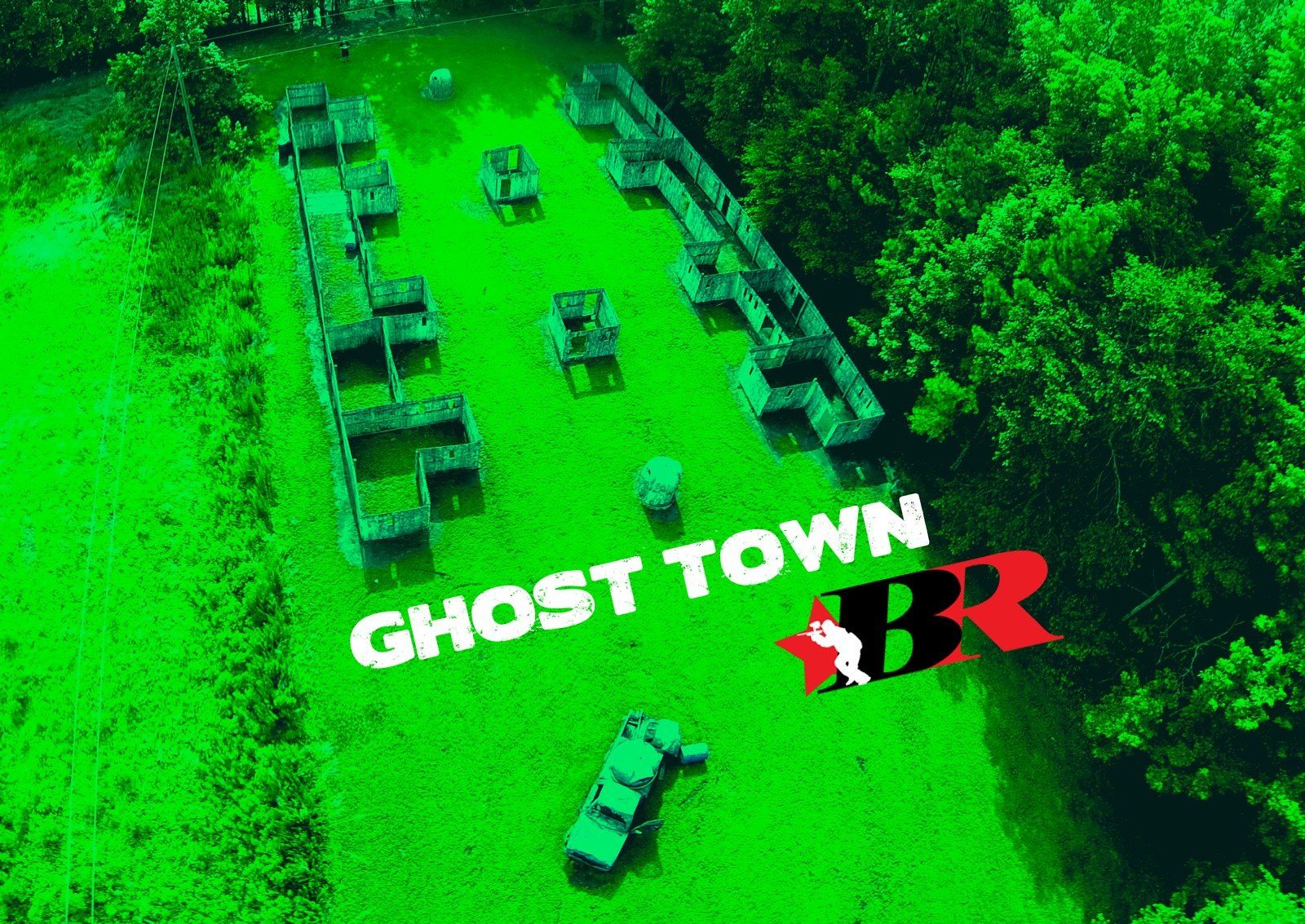The Ghost Town Field at Black River An aerial view of a paintball field with a car parked in the middle of it.