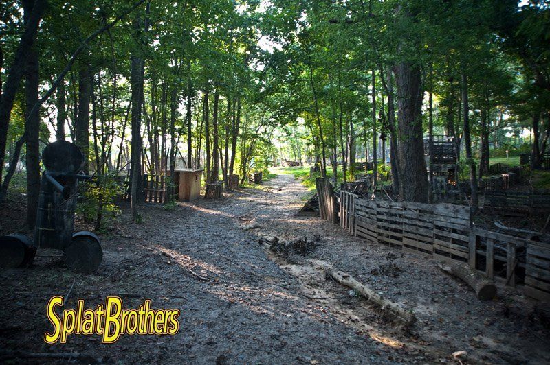 A dirt road in the woods with the words splatbrothers on the bottom