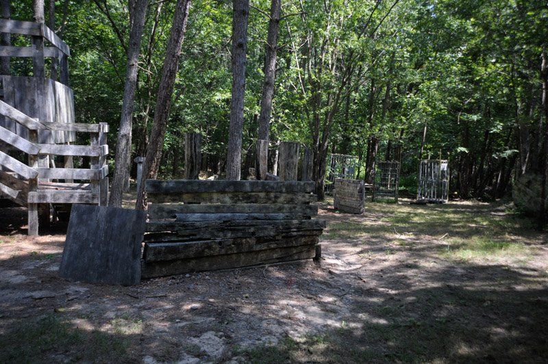 A paintball field in the middle of a forest.