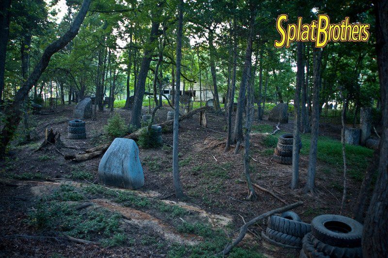 A paintball field with a sign that says splat brothers