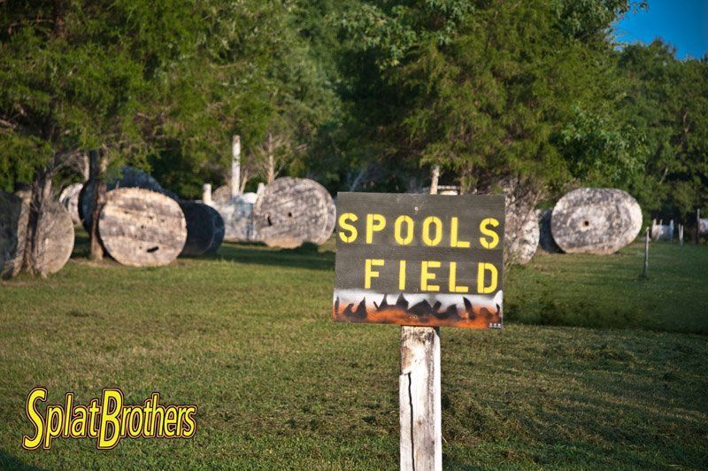 A sign in a field that says spools field