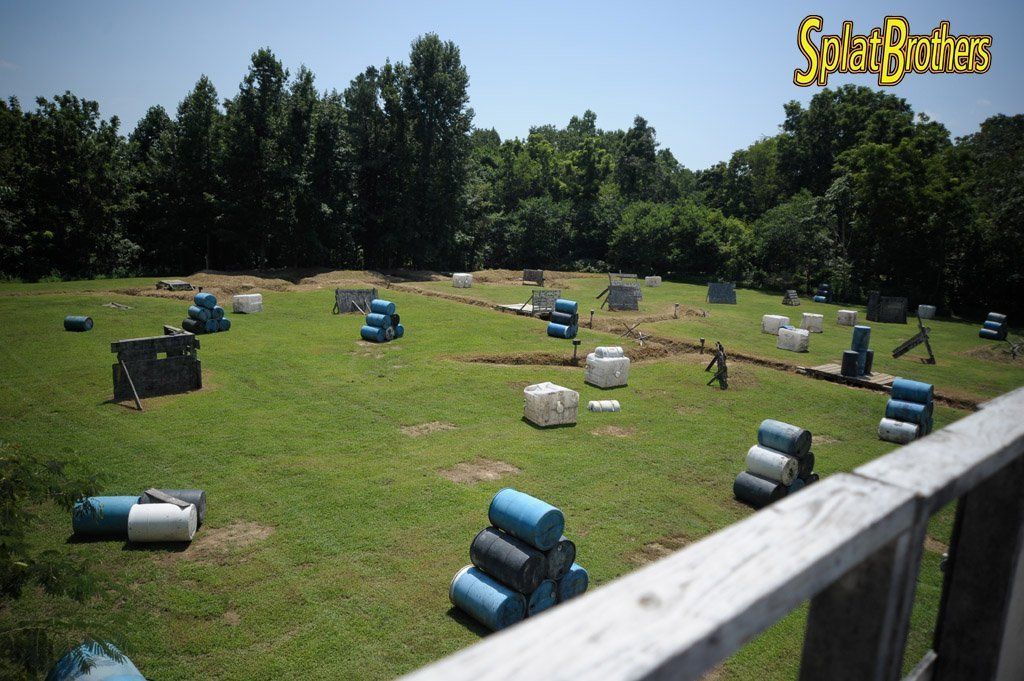 A paintball field with a sign that says spray brothers