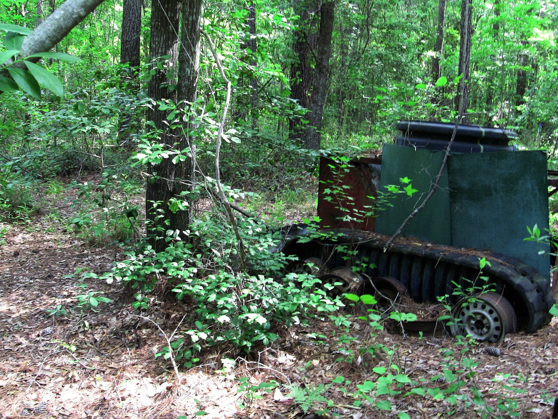 A jeep is sitting in the middle of a forest