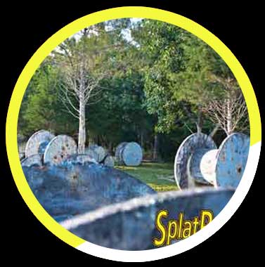 A circle with a bunch of spools of wire in it and trees in the background.