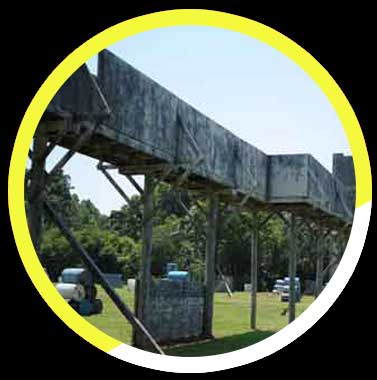 A large metal structure is in the middle of a field.