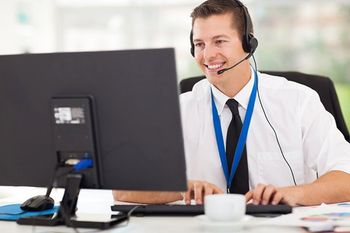 a man working his desktop and is on a call