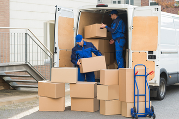 two technicians unloading items from their van