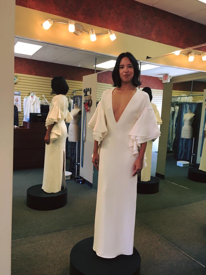 Girl wearing V-neck white sheath gown