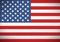 American flag with red and white stripes, blue field of white stars.