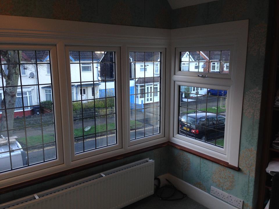 A large bay window with timber surrounds painted white. Beneath which is a low profile radiator.