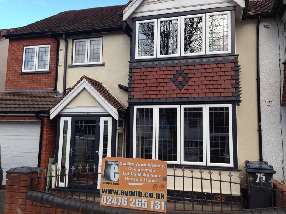 A large home with two large windows and a modern composite door. This shows the entire front of the property.
