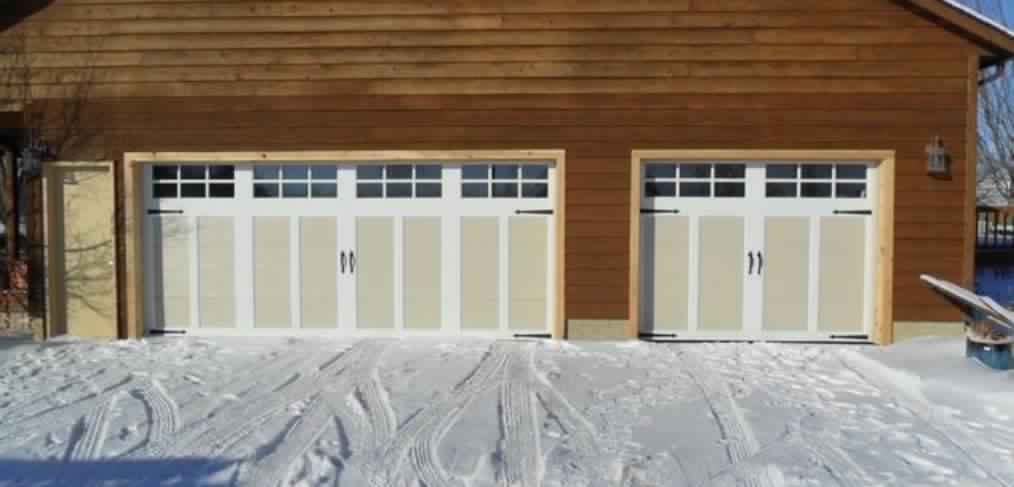 garage door in front of snowy driveway