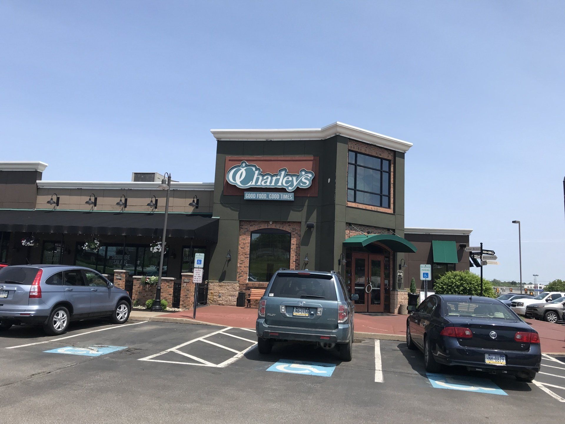Cars are parked in front of a restaurant called barley 's