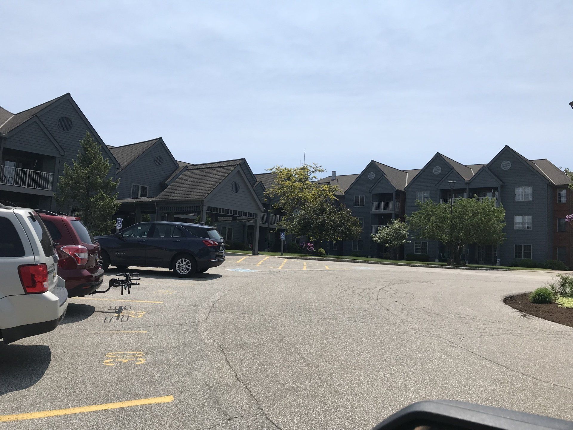 A parking lot with cars parked in front of a building