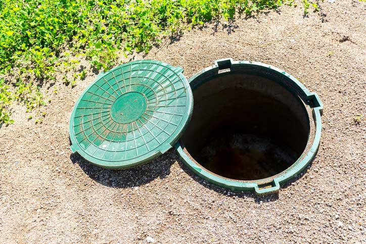 Opened Rural Septic Tank with Green Plastic Cover — Baldwinsville, NY — Aces-Four Septic Service