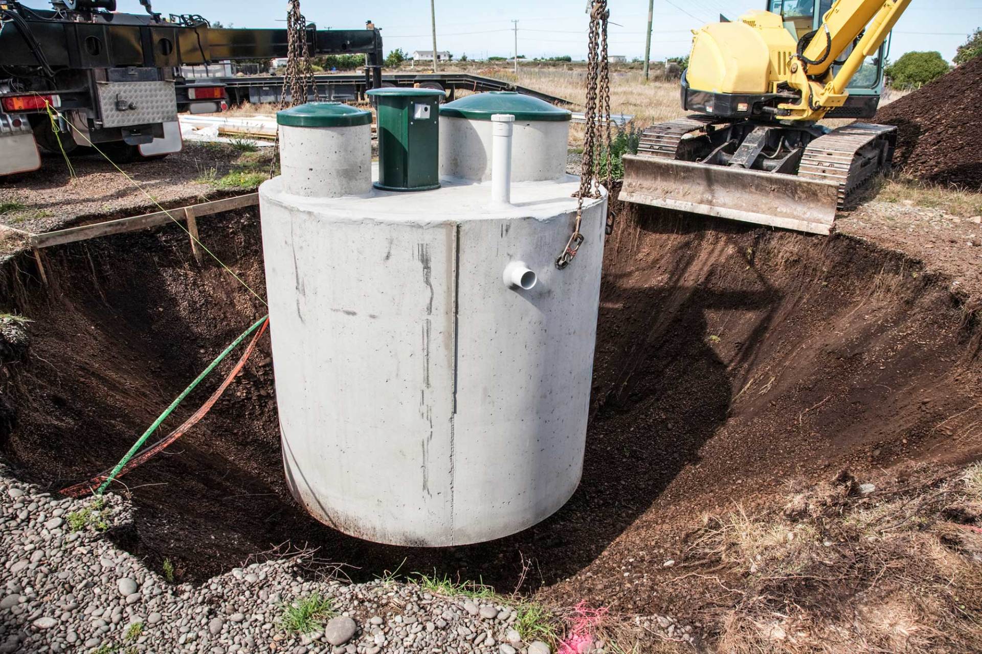 Septic Tank Being Lowered Into Ground — Baldwinsville, NY — Aces-Four Septic Service