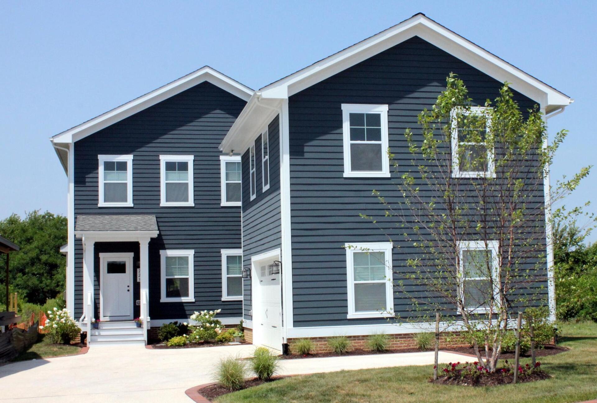 A large blue house with white trim and windows