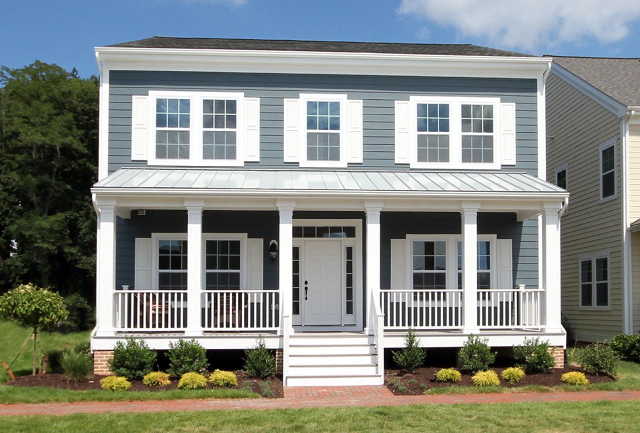 A blue and white house with a large porch
