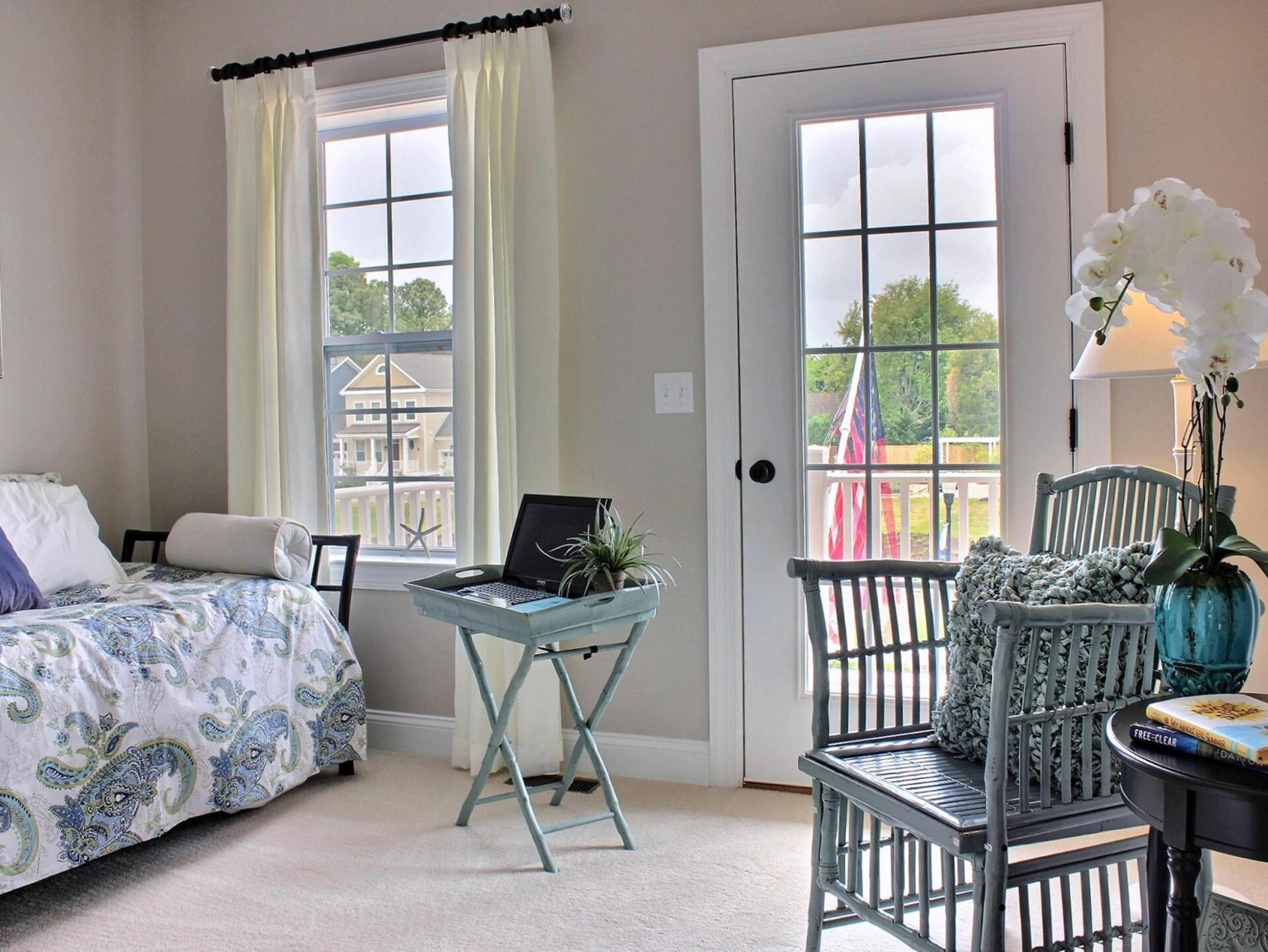 A bedroom with a bed , chair , table and window
