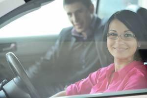 Young Attractive Couple Driving A Car — Chicago, IL — Clover Insurance Agency Young Attractive Couple Driving A Car — Chicago, IL — Clover Insurance Agency