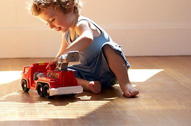 Child Playing on Wood Floor - Flooring Installation in Iowa City, IA