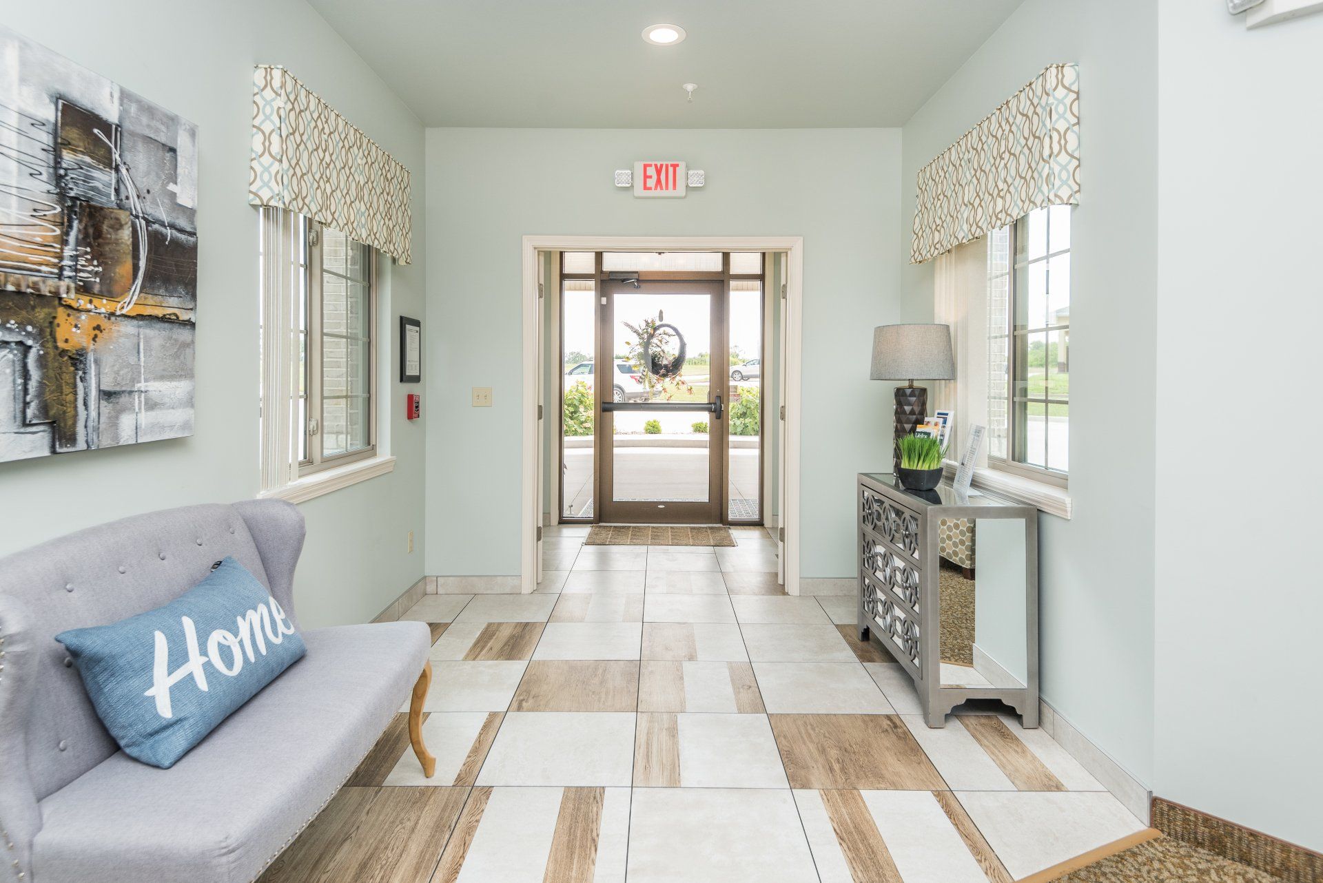 A hallway with a couch and a pillow that says