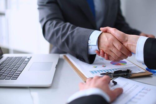 Lawyer and Client Shaking Hands — Family Law Attorneys in Sioux City, IA Motorcycle accident lawyer shaking hands with a client in Sioux City, IA
