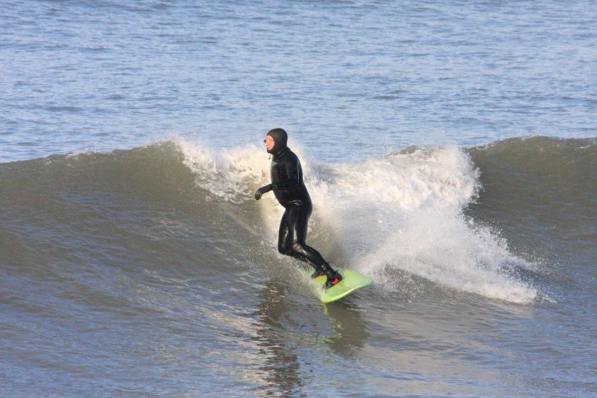 Surfer at Westward Ho! making the most of a small but perfect winter swell here. Make memories while surfing at Westward Ho!
