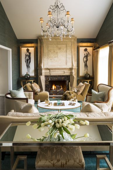 A living room with a fireplace and a chandelier