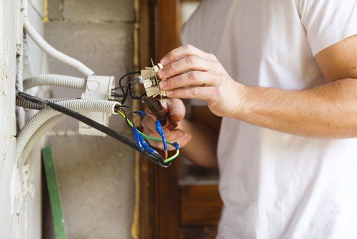 Electrician installing light in a new house