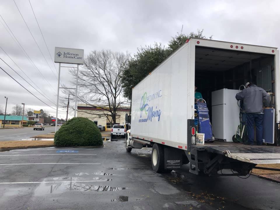 jr brown inc crew unloading truck in wet weather