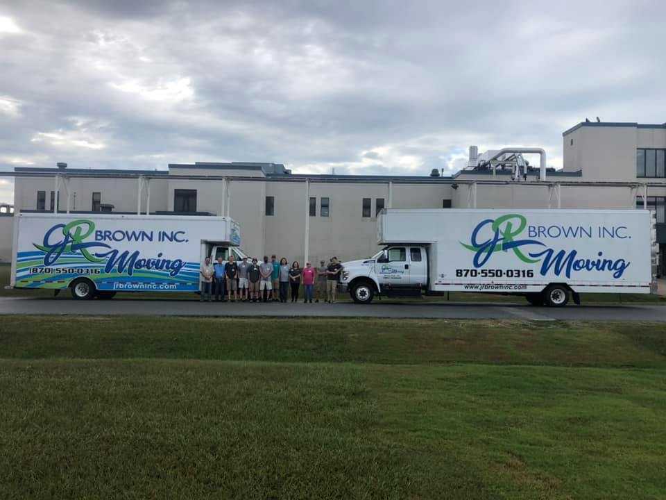 jr brown inc team posing with trucks after winning best movers award