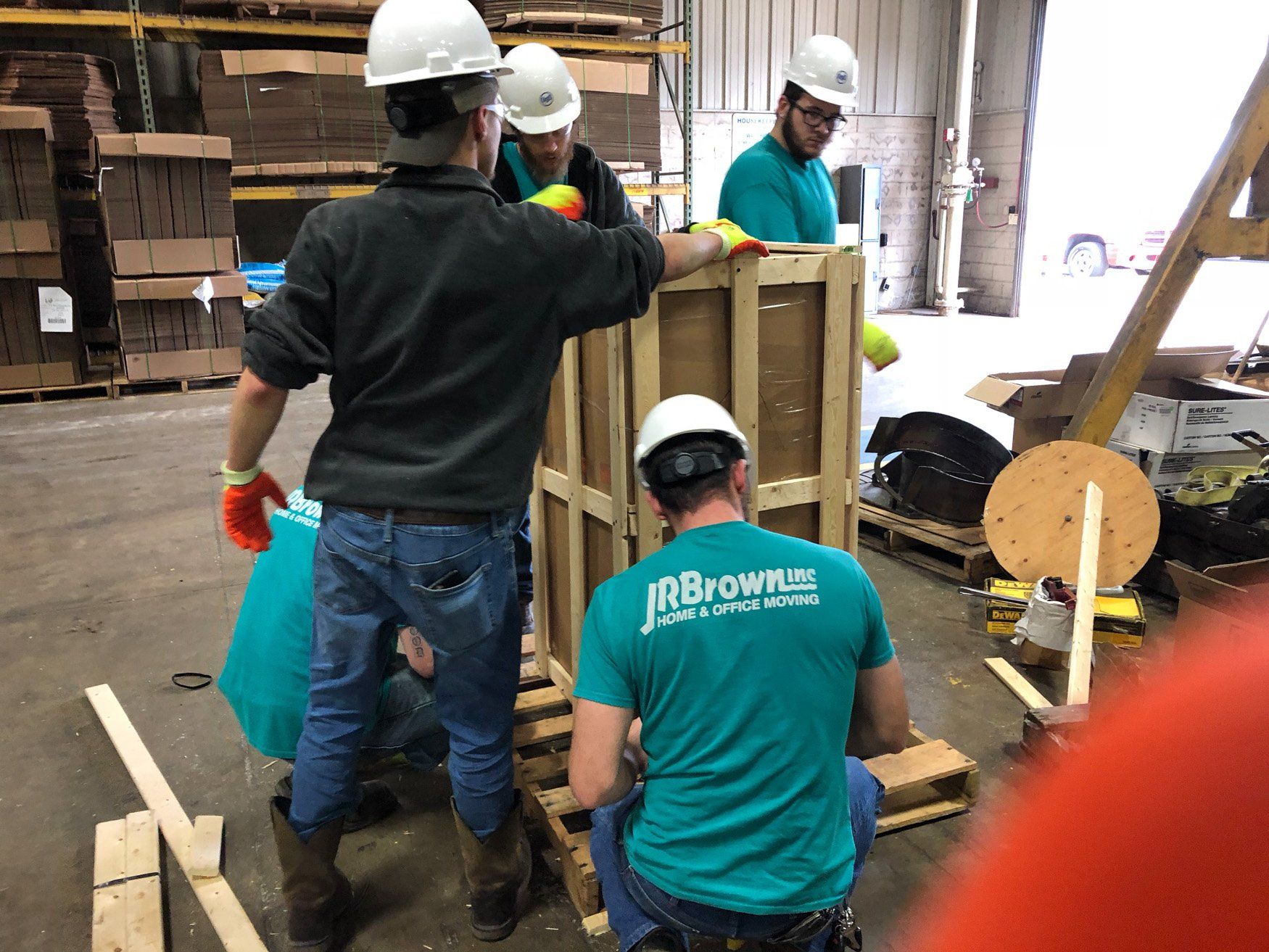 jr brown employees crating delicate equipment for transport
