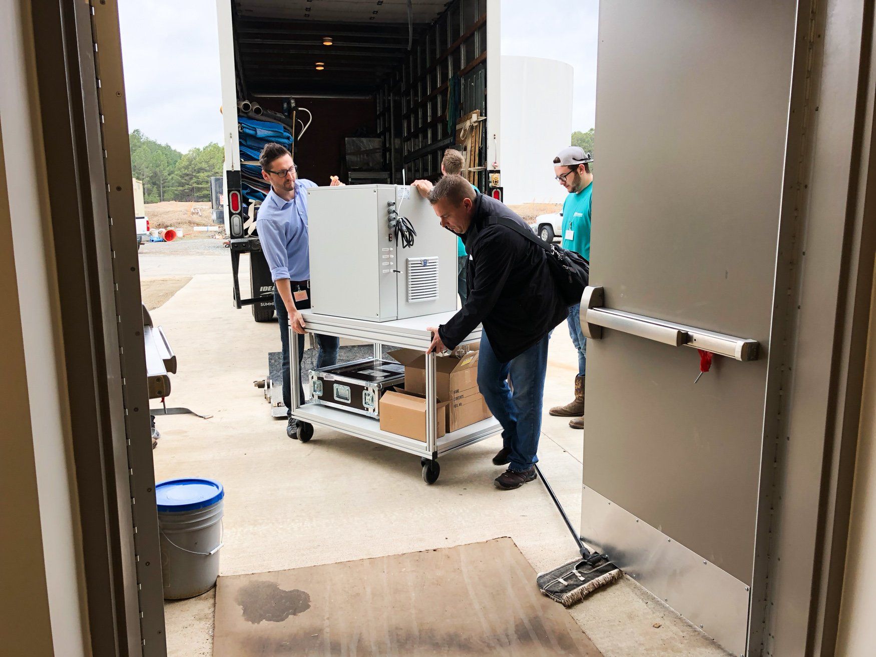jr brown employees moving medical imaging equipment