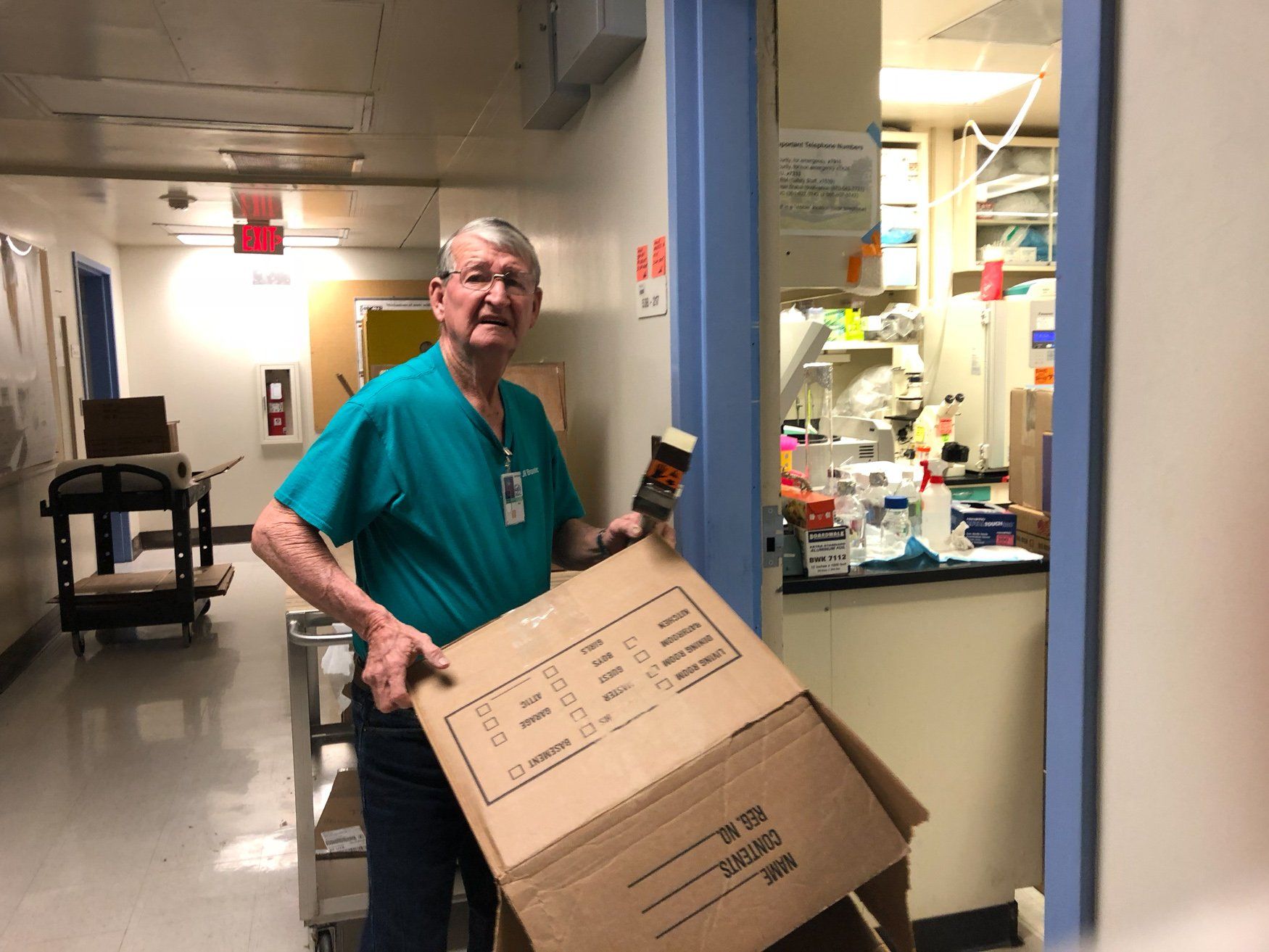 jr brown employee preparing box to pack goods into for move