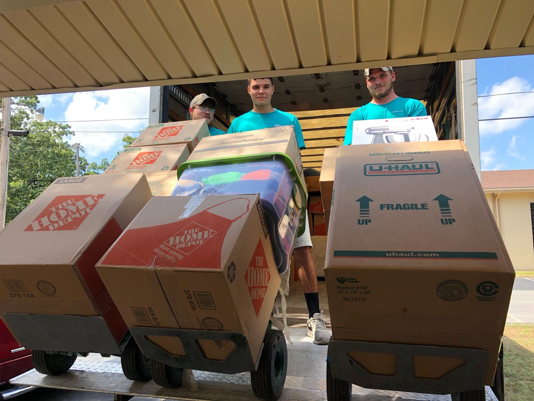 A group of men are loading boxes into a truck.