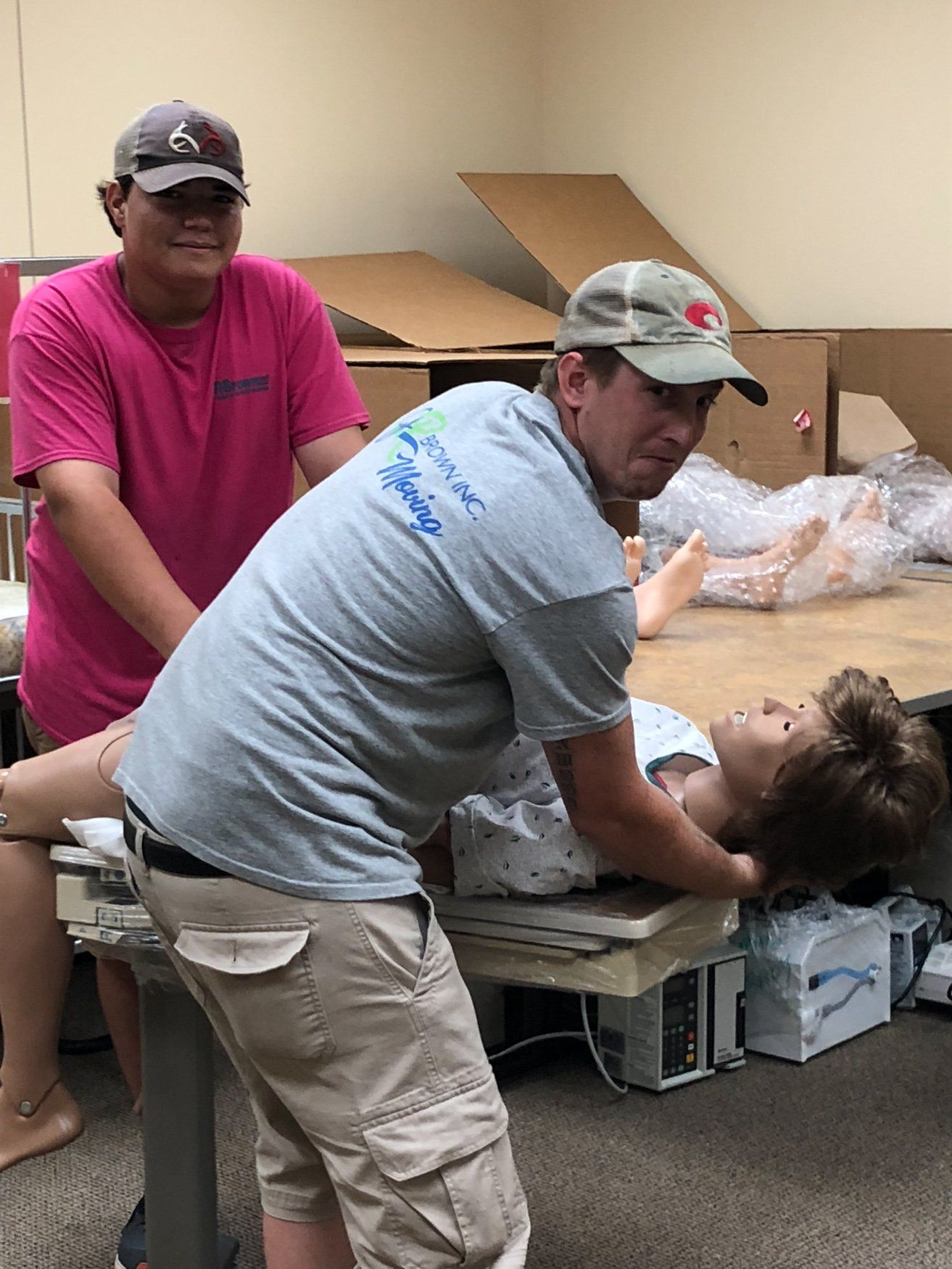 jr brown employees moving medical training equipment